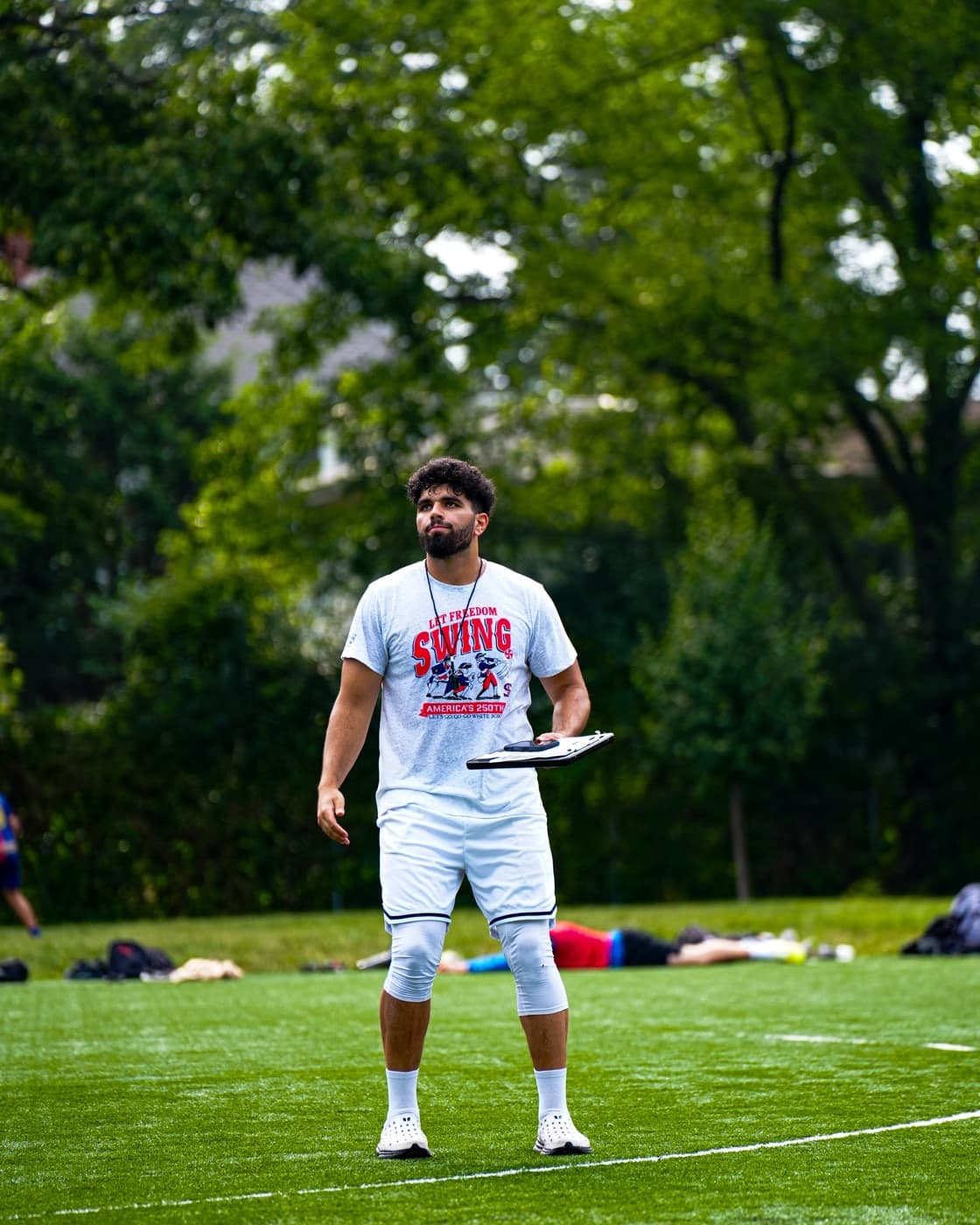 Mohamed Abdelhafez on the sideline with a clipboard